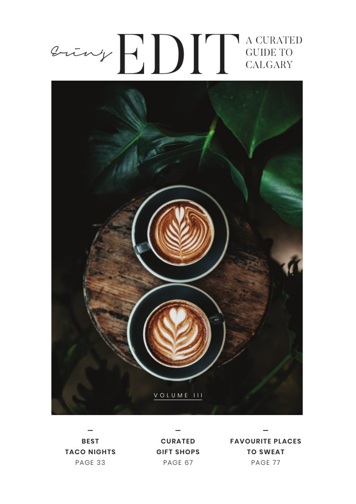 Cover of Erin's Edit Volume III, two lattes on a dark wood table among leaves