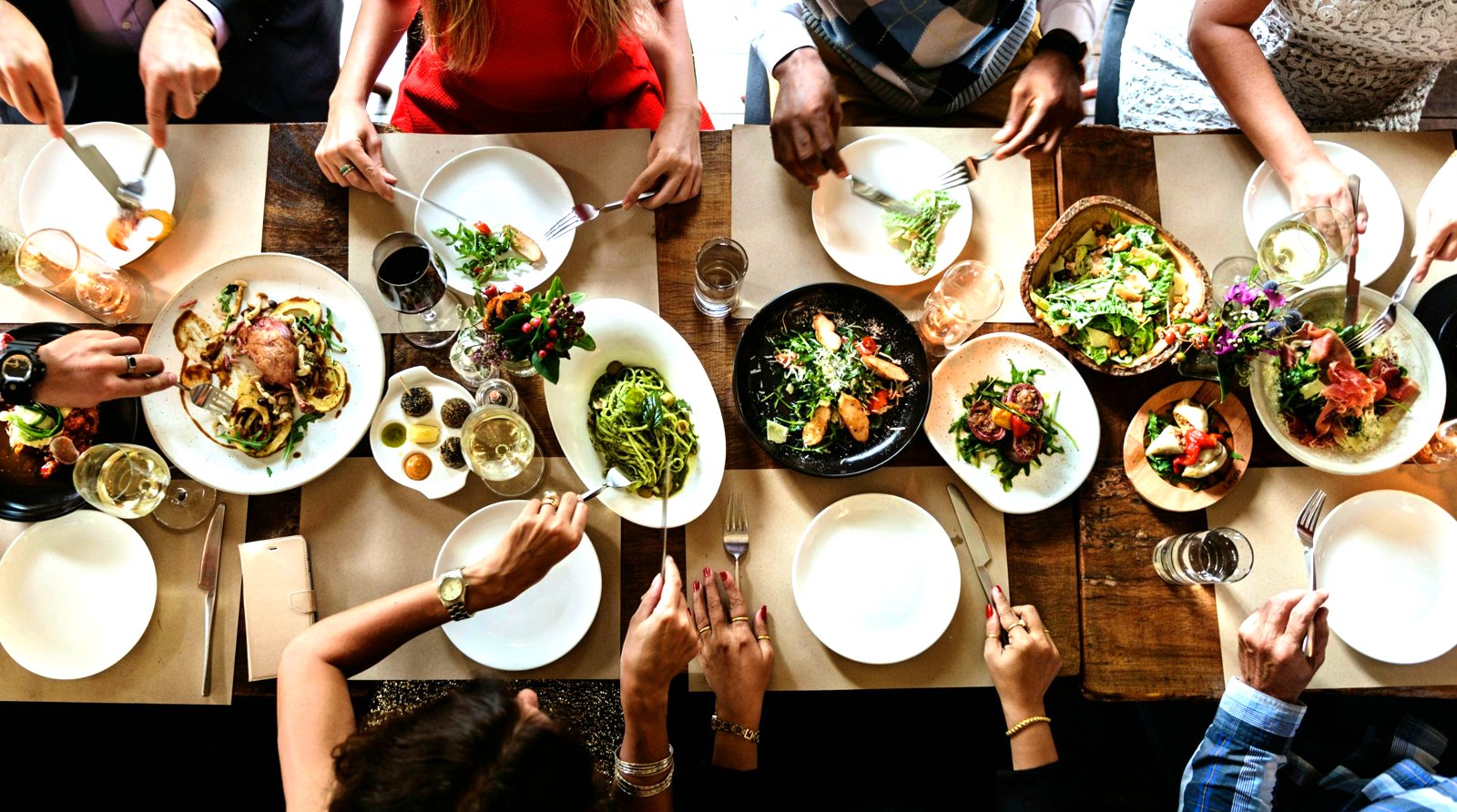 Friends sharing dinner around a long table