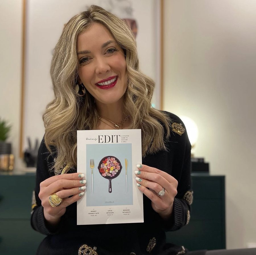 Erin smiling and holding Volume IV
